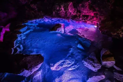 A cave bathed in purple light.