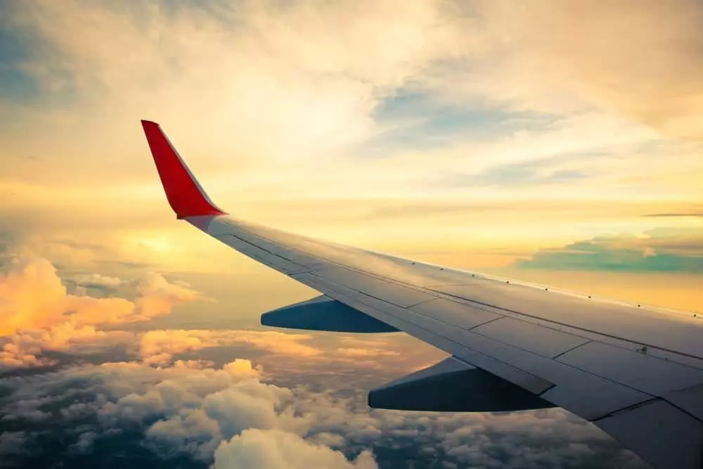 The wing of an airplane and a beautiful sky.