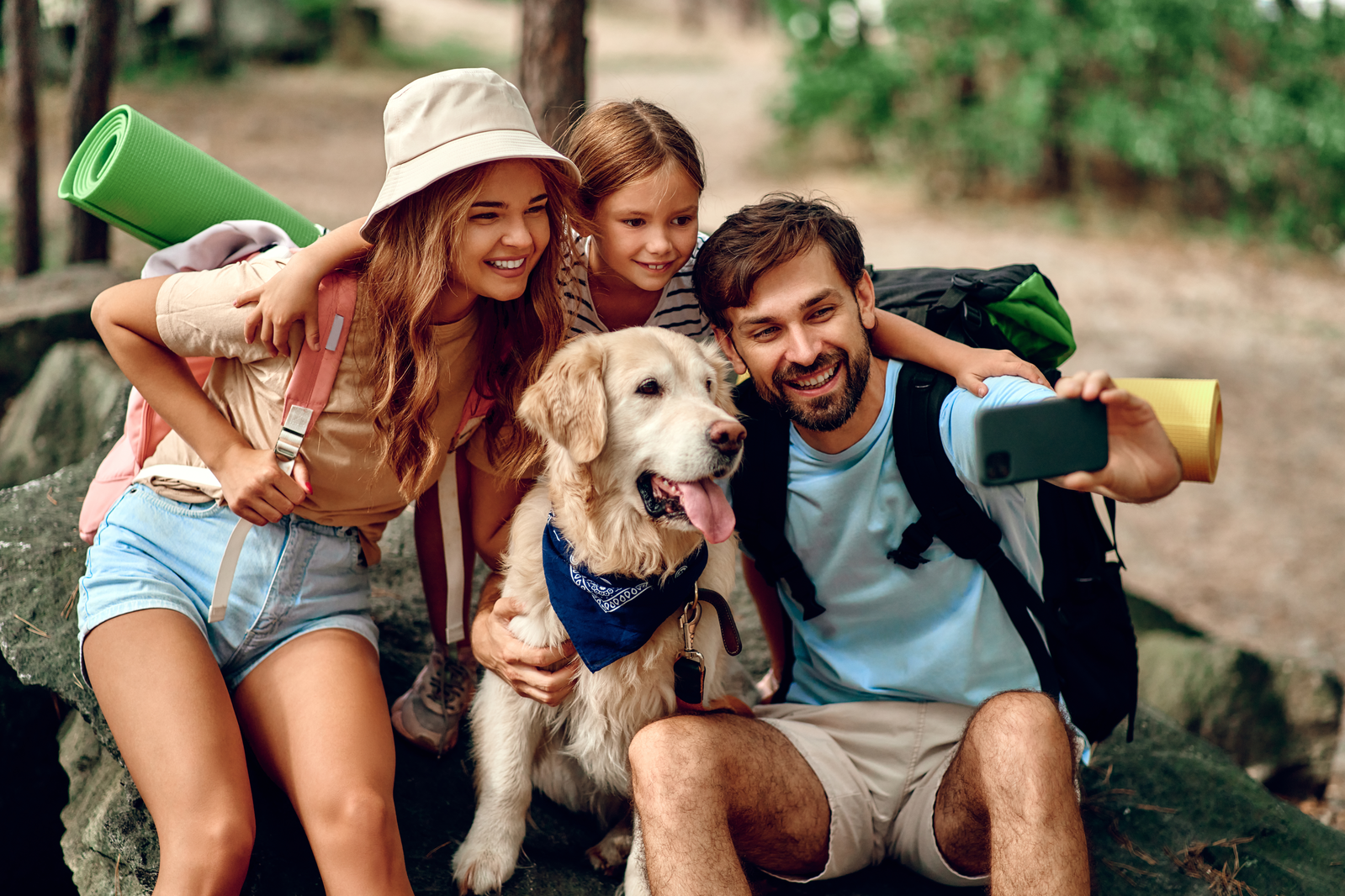 family with dog hiking
