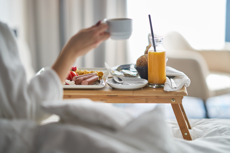woman eating breakfast in bed