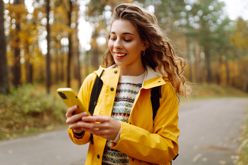 woman smiling while texting