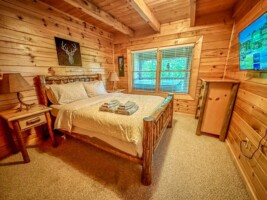 Main level bedroom with queen size bed and 32