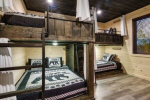 The bunk room features 2 Queen and 2 Full bunks and a full ensuite bathroom!